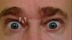 Close-up of menacing look, furrowed brows. Adult man feeling anger. Expression of emotions through the eyes.