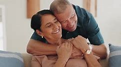 Love, home and happy elderly couple hug, smile and enjoy quality time together