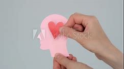 World mental health day concept. Paper human head symbol and heart on blue background, 4k video