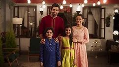 Portrait of Happy Indian Nuclear Family in Traditional Clothes Posing Together. Gorgeous Parents and Their Cute Two Kids Looking at the Camera, Happy in Their Newly Purchased Home. Slow Motion Zoom in