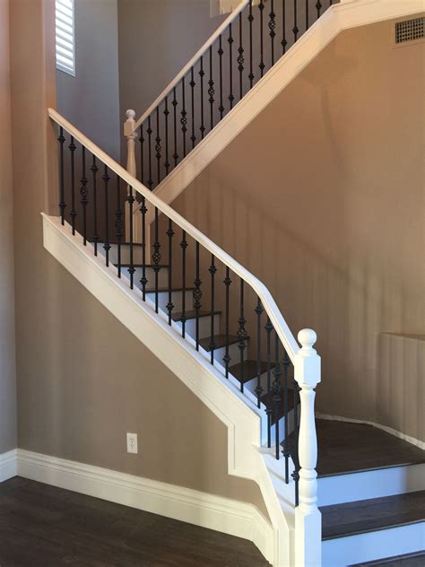 White railing with black spindles wood stairs with white risers ...