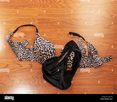 Lingerie, a bra and black panties, lying on a wood floor Stock Photo ...