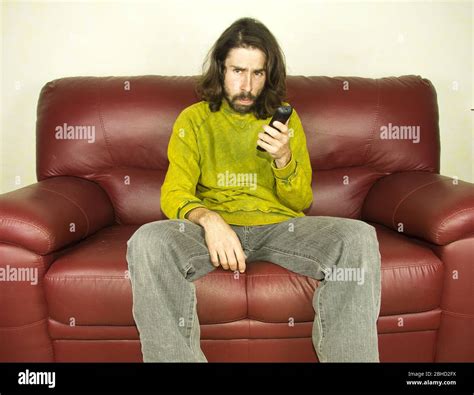 man on the couch remote control Stock Photo - Alamy