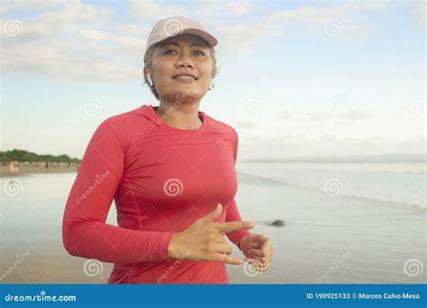 Fit and Happy Middle Aged Woman Running on the Beach - 40s or 50s ...