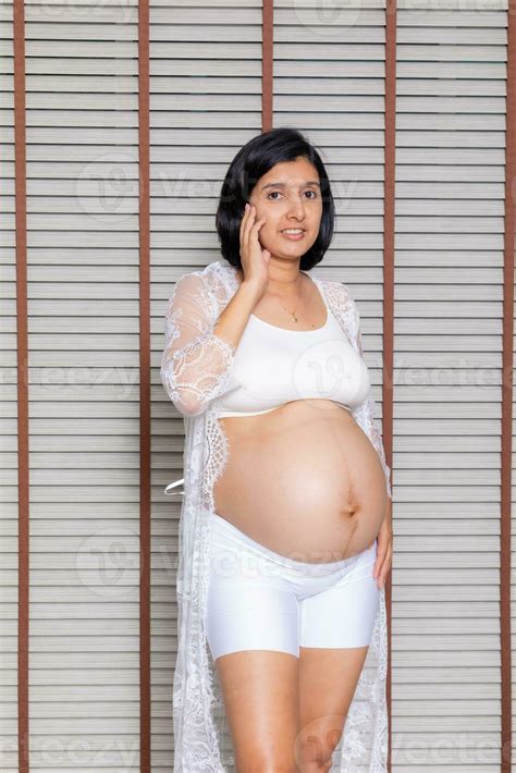 Portrait of a pregnant woman touching her big belly close up, mother, pregnancy, people and ...