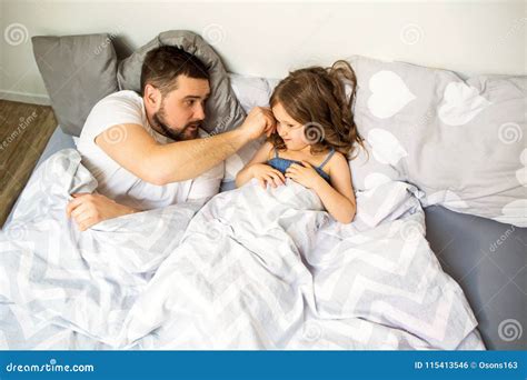 Dad and Daughter Have Fun at Home on the Bed. Father`s Day. Stock Photo ...