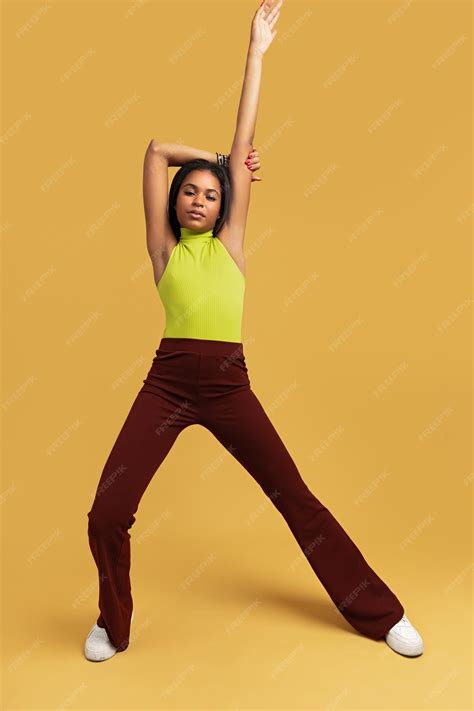 Premium Photo | Trendy Hispanic woman raising arm