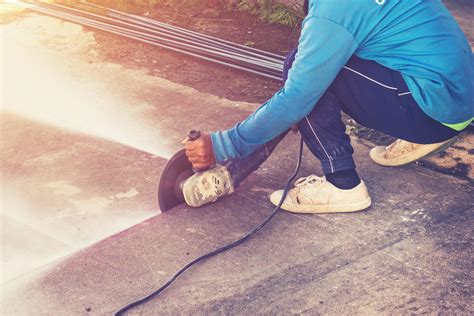 Close up hand man cutting concrete floor with machine. 19925052 Stock ...