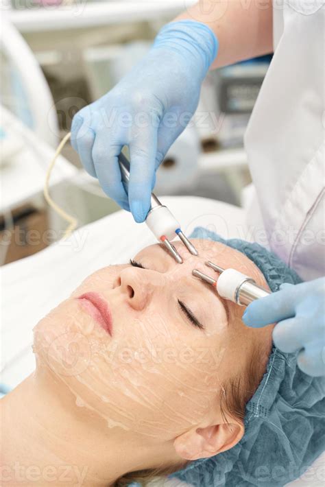 Dermatology anti age treatment. Microcurrent medicine procedure. Woman ...