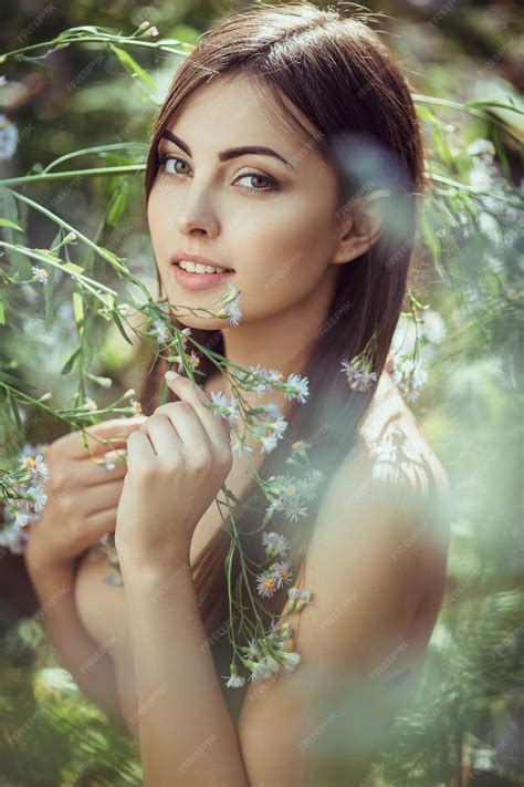 Premium Photo | Beautiful young naked woman portrait in flower meadow ...