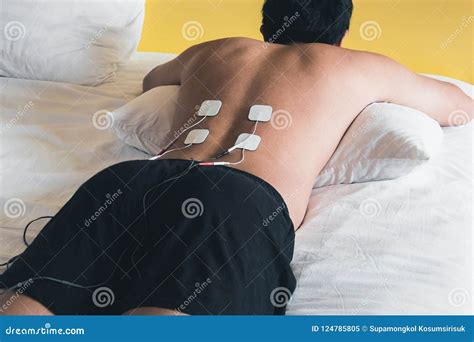 Patient Applying Electrical Stimulation Therapy on Back. Electrical ...