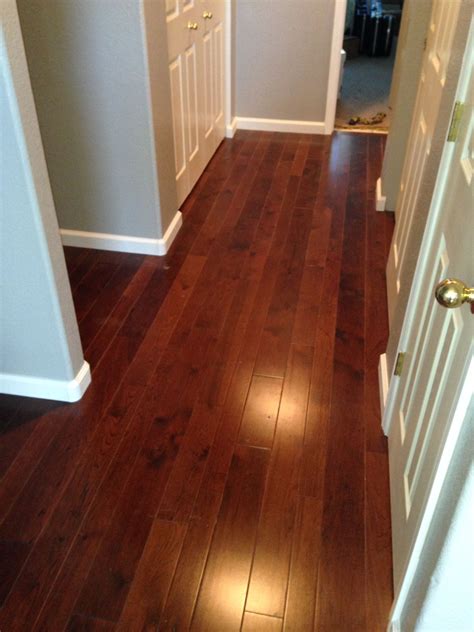 Dark Hickory Wood Floors with White Baseboards and Grey Walls