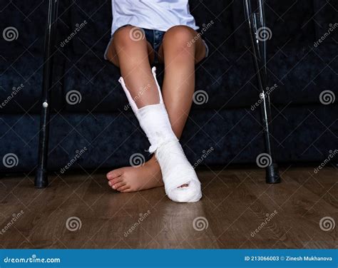 A Young Girl with a Broken Ankle in a Cast, with a White Bandage on One ...