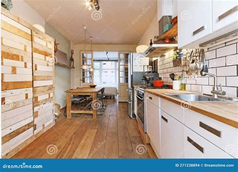 A Kitchen with Wooden Floors and White Cabinets Stock Photo - Image of ...