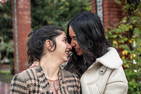 portrait of young multiethnic couple latin girlfriends kissing 54492483 Stock Photo at Vecteezy
