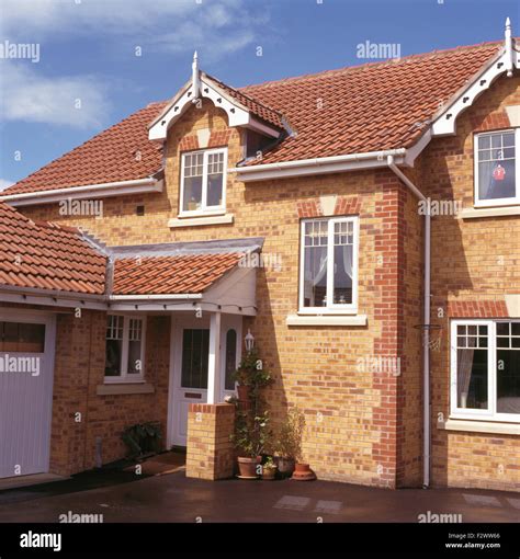 Exterior of new-build brick house on small estate Stock Photo - Alamy
