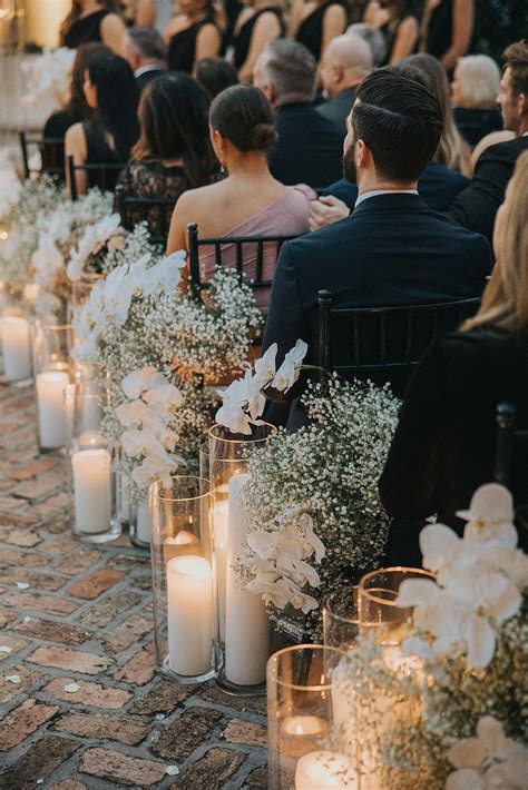 wedding aisle decor with baby breath, orchids and candles | White ...