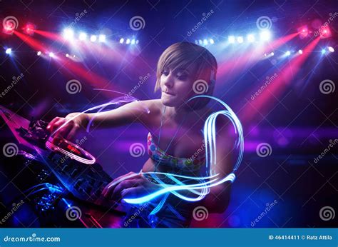 Disc Jockey Girl Playing Music with Light Beam Effects on Stage Stock ...