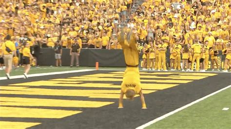 Moment Cheerleader suffers wardrobe malfunction mid college football routine leaving fans ...