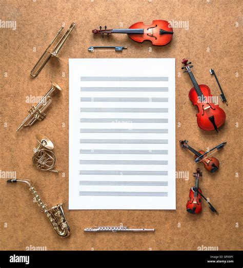 Set of five golden brass wind and four string musical orchestra instruments: saxophone, trumpet ...