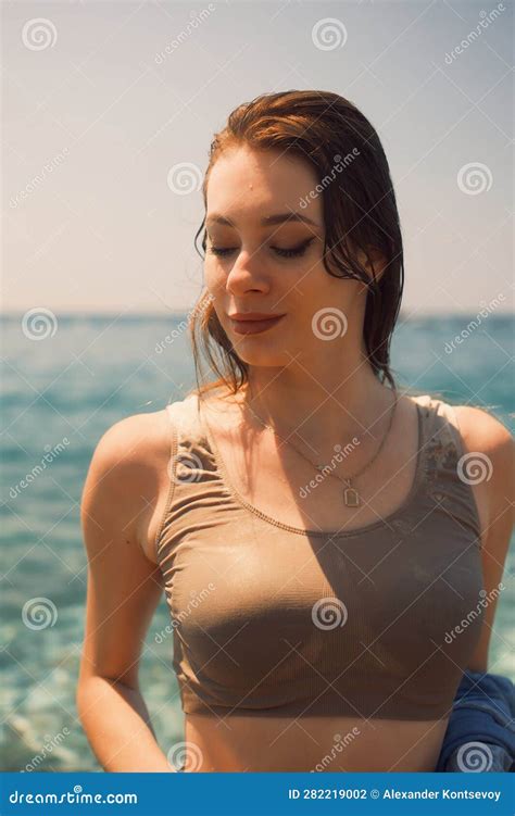 Portrait of a Girl in Wet Clothes. Her Gaze is Downcast. Eyes Closed ...