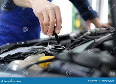 The Mechanic Fills the Tank Power Steering Fluid Stock Image - Image of mask, professional: 82640093