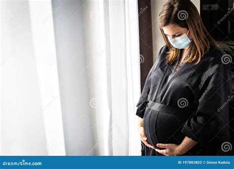 Pretty Young Brunette, Pregnant Woman with a Medical Face Mask during Covid-19 Pandemic ...