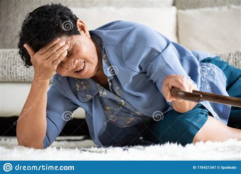 Sick Asian Old Woman with Headache Lying on the Floor after Falling Down at Home. Senior ...