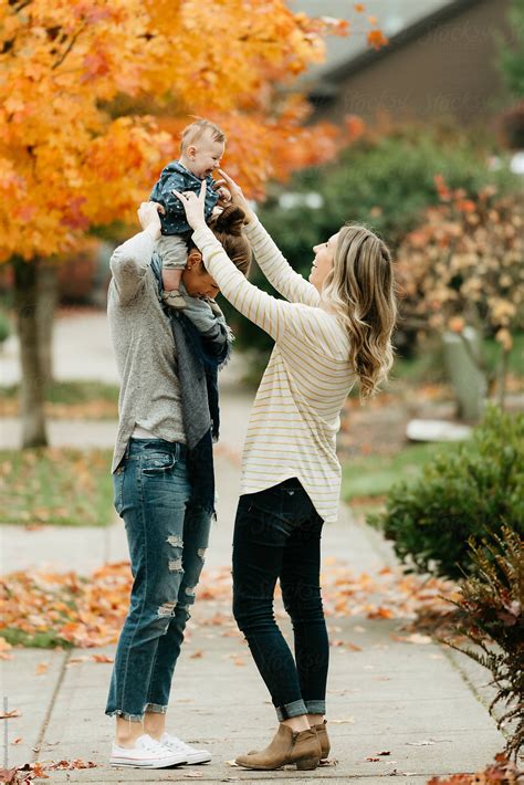 "Lesbian Moms Walking With Baby Daughter On Sidewalk In The Fall." by ...