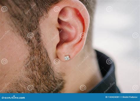 Earring in the Male Ear. Piercing Part of the Body Stock Image - Image ...