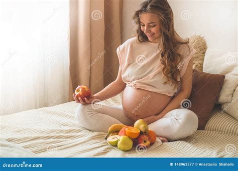 Pregnancy and Healthy Organic Nutrition. Pregnancy and Grapefruit. Pregnant Woman Enjoying Fresh ...