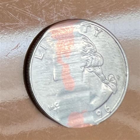 A quarter got trapped in the brushes by Roomba and polished part way ...