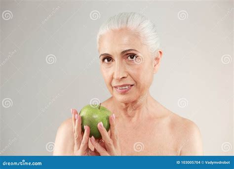 Concentrated Naked Elderly Woman Holding Apple. Stock Photo - Image of ...