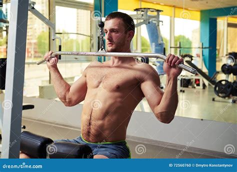 Man is Doing Shoulder Exercises on Cable Machine Stock Photo - Image of ...