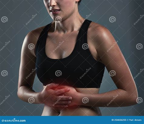 Dehydration Commonly Has a Role in Stomach and Abdominal Pains. Studio Shot of a Sporty Young ...