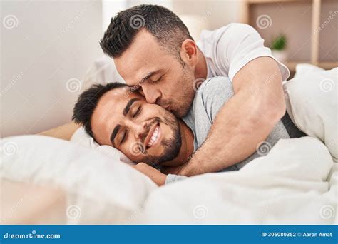 Two Men Couple Lying on Bed Hugging Each Other Kissing at Bedroom Stock ...
