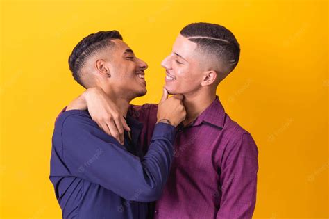 Download Gay Latino Couple Yellow Wallpaper | Wallpapers.com