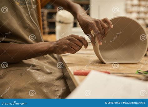 African Ceramist Making Holes in a Pot at a Workbench in a Studio Stock ...