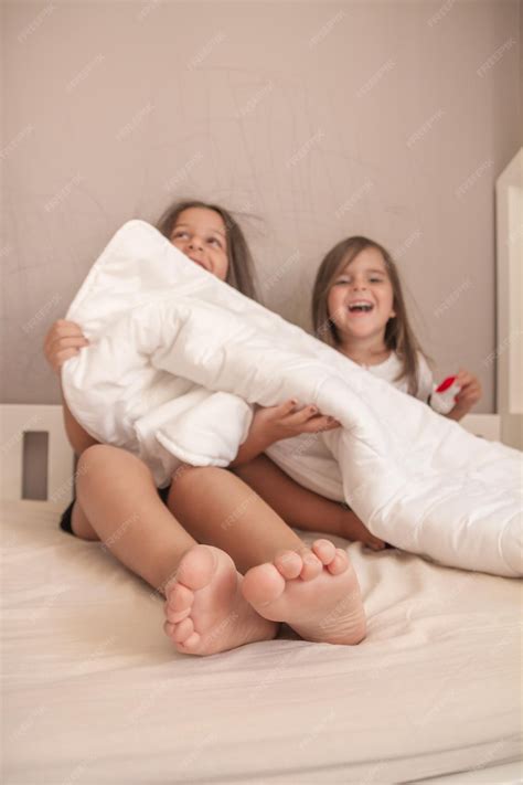 Premium Photo | Little girls playing in their room and tickling and ...
