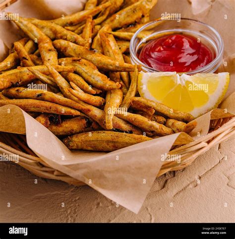 fried fish with lemon and ketchup Stock Photo - Alamy