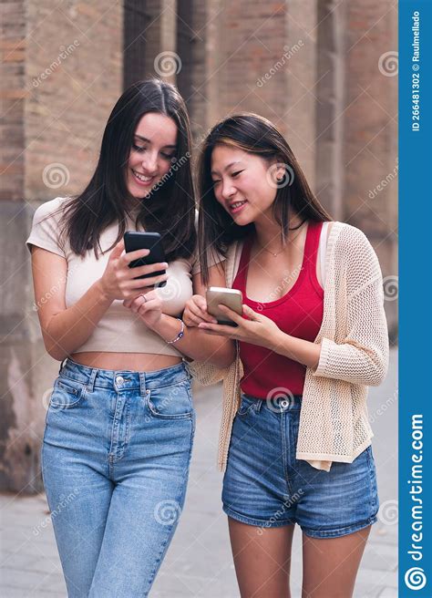 Women Smiling Happy Looking at Their Cell Phones Stock Photo - Image of ...