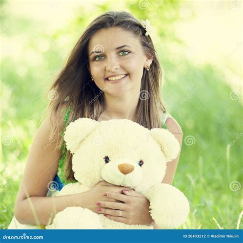 Beautiful Teen Girl with Teddy Bear in the Park at Green Grass. Stock ...