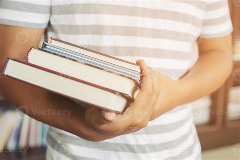 close up student young man hand holding books are placed front ...