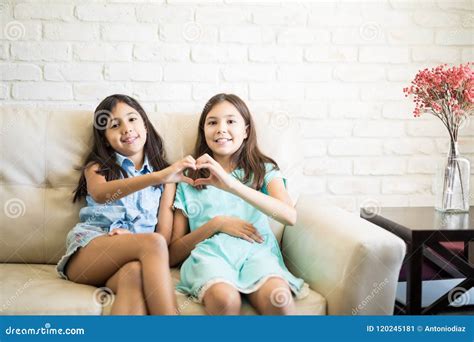 Dos Hermanas Jovenes Que Hacen El Corazón Con Los Fingeres Imagen de ...
