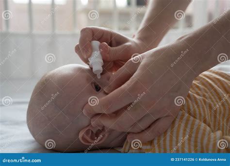 Mother is Treating Newborn Eye Inflammation by Givining Eye Drops ...