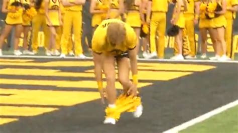 Moment Cheerleader suffers wardrobe malfunction mid college football routine leaving fans ...