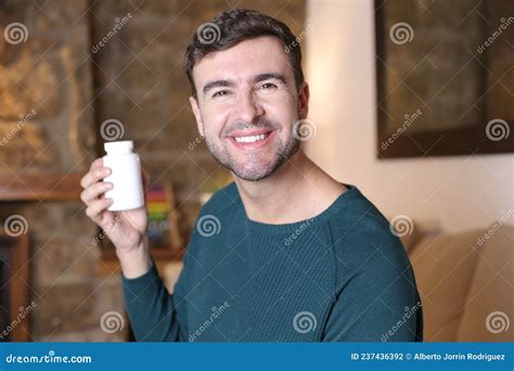 Man Holding White Pill Bottle Stock Photo - Image of beauty, delighted: 237436392