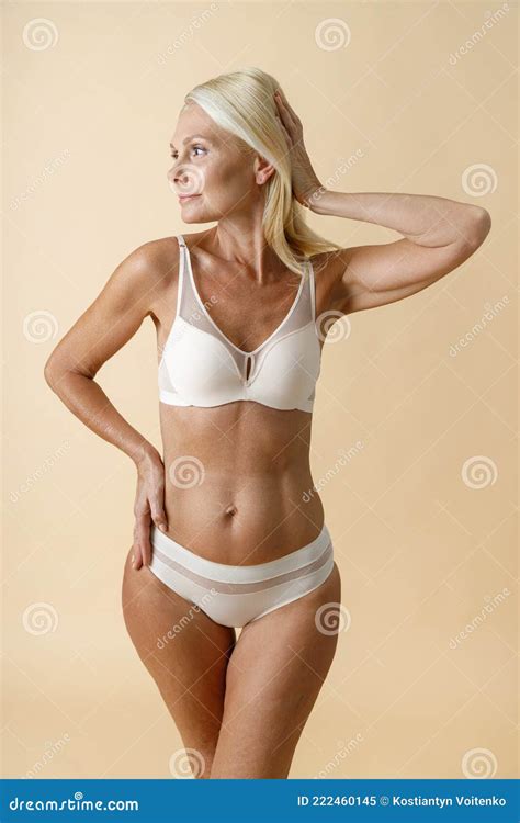 Cheerful Mature Blonde Woman with Perfect Body Shape in White Underwear ...