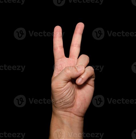 The man's hand that holds two fingers is a V sign, meaning victory. Or ...