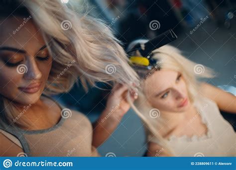 Hairdresser Female Making Hair Extensions To Young Woman with Blonde ...